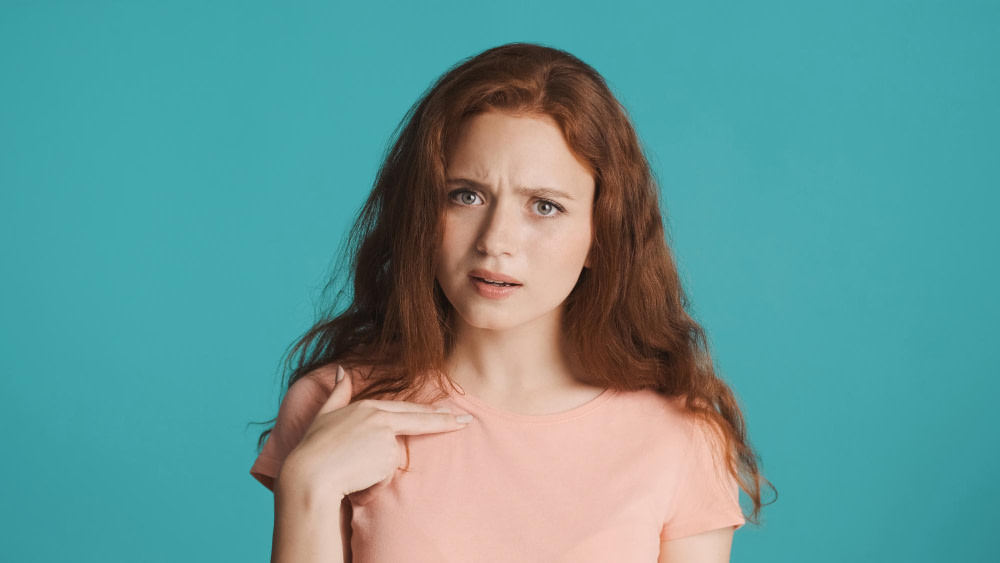 Confused Redhead Girl Pointing Finger on Herself