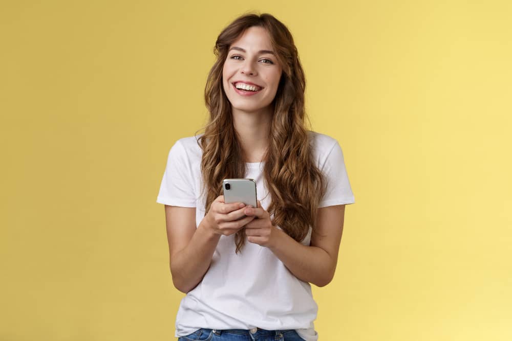 Lively Enthusiastic Friendly Smiling Happy Woman Using Smartphone 
