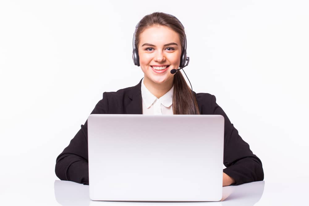 Young Woman Working in Office With Laptop and Headphones on White Wall, Customer Service and Call Center.