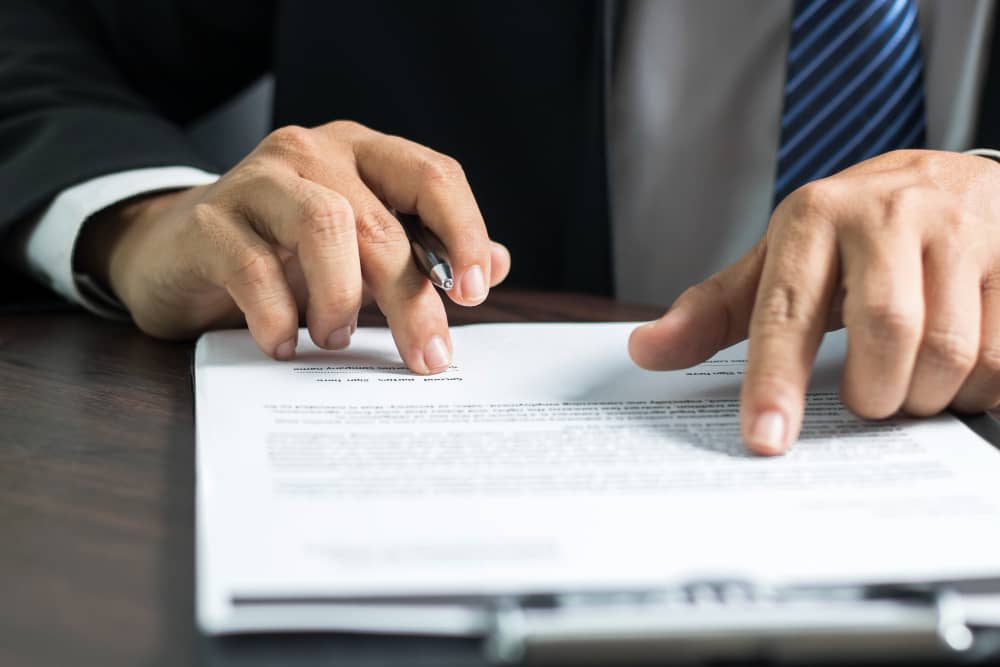 Businessman or Lawyer Reading and Signing on Contract Paper 